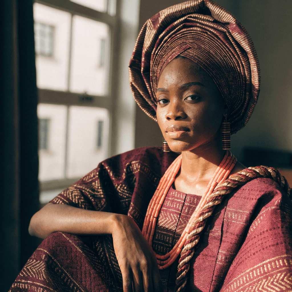 Nigerian bride in a hand-woven aso oke iro and buba with gele, photographed in a Lagos atelier