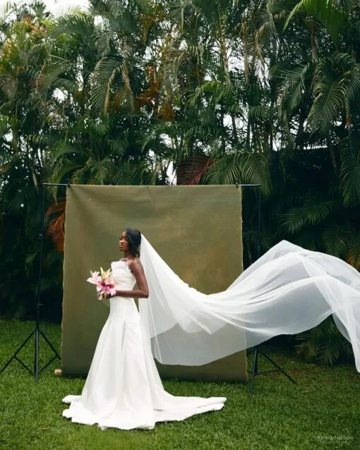 Bride wearing a finished Bojamiley bespoke wedding dress, showing fit through the bodice, waist and train