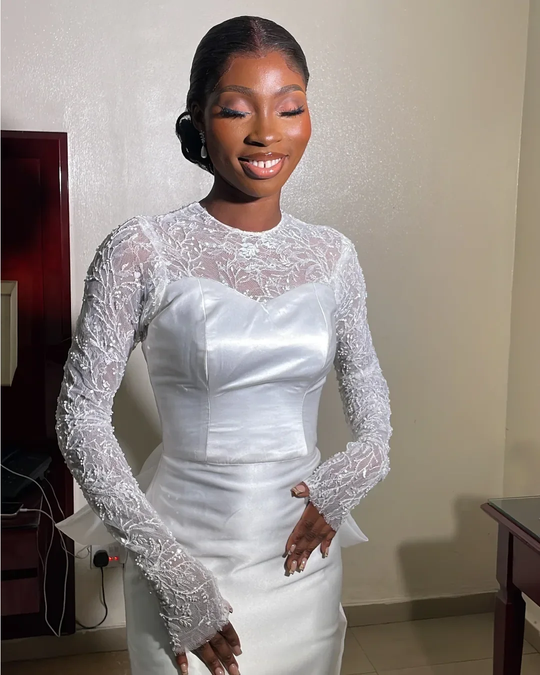 Beaded floral lace sleeve and sweetheart neckline detail on the Seraphine white satin wedding dress