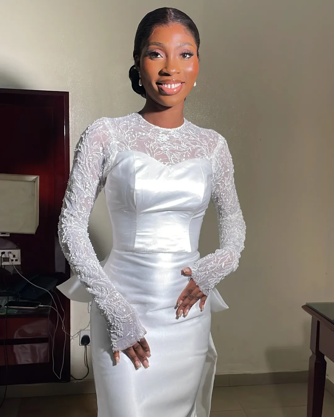 Bride in the Seraphine white lace sleeve satin wedding dress by Bojamiley Lagos