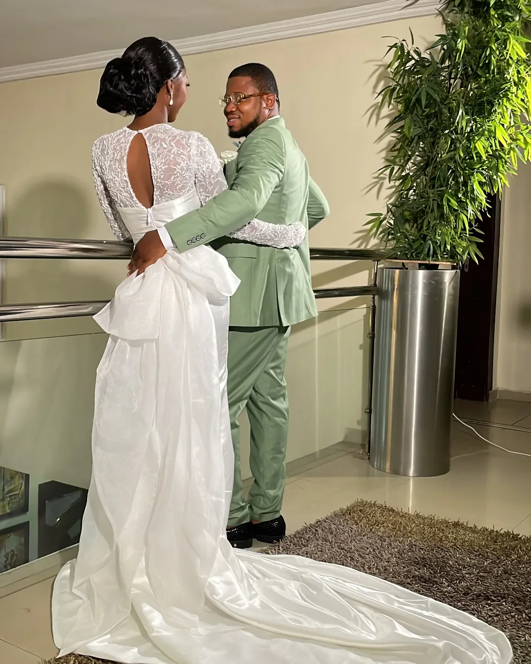 Full length view of the Seraphine white satin wedding dress showing the bow and sweeping train